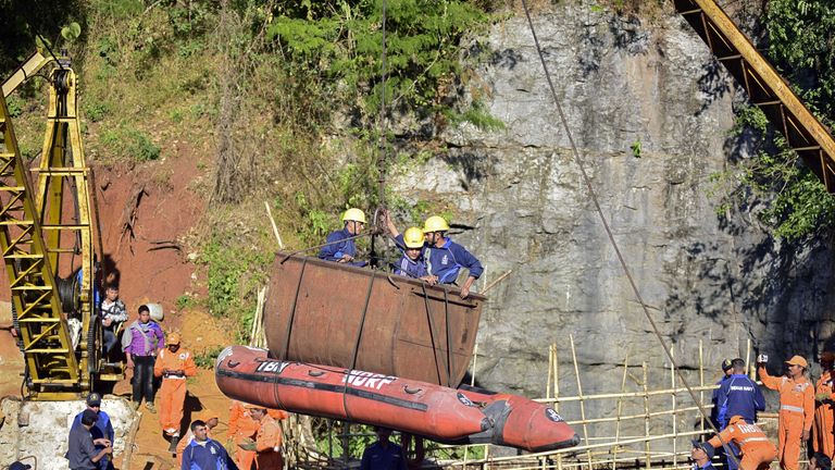 Indian navy personnel emerge from the mine in Meghalaya