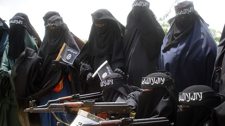 Somali women carry weapons during a demonstration organized by the islamist Al-Shabaab group which is fighting the Somali government in Suqa Holaha neighborhood of Mogadishu, on July 5, 2010