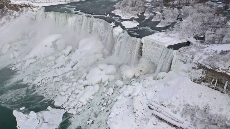 An aerial photo taken over the American side shows water flowing around ice due to subzero temperatures in Niagara Falls, New York