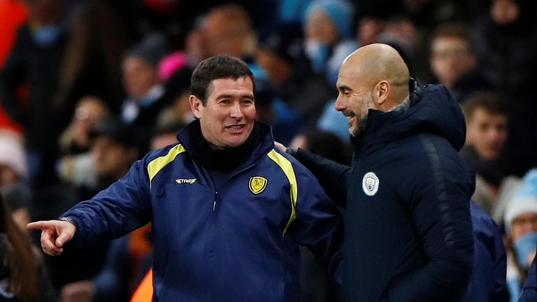 Pep Guardiola (right) consoles Burton Albion coach Nigel Clough
