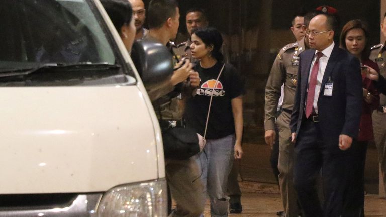 Saudi teen Rahaf Mohammed al-Qunun walks accompanied by UNHCR members and Thai immigration authorities outside Suvarnabhumi Airport in Bangkok