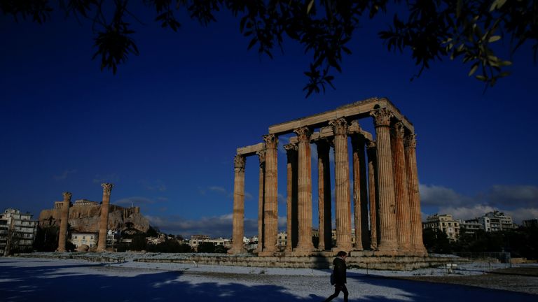 A visitor at the ancient Temple of Zeus in Athens after snow fell there