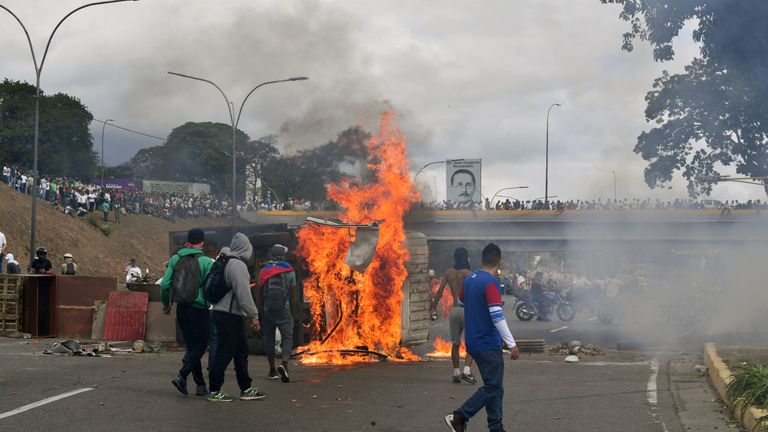 A van is set on fire by Venezuelan opposition demonstrators