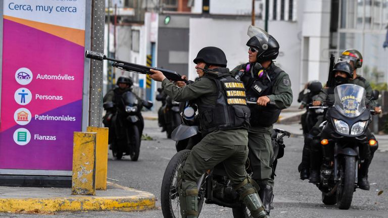 Riot police fire at demonstrators in Caracas