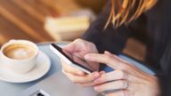 close up of hands using mobile application on smartphone, woman checking emails on her smart phone in cafe