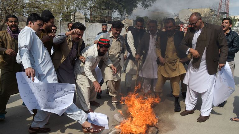 Pakistani men burn an effigy of Indian Prime Minister Narendra Modi during a protest in Peshawar