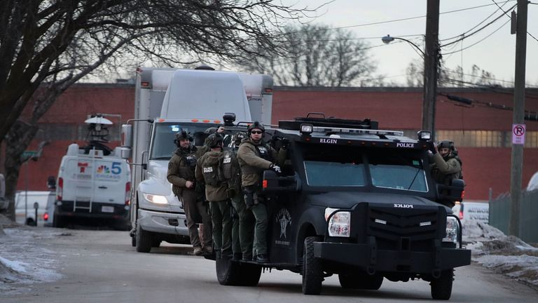 Police secure the area following a shooting at the Henry Pratt Company