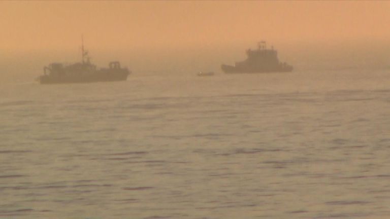 A Border Force boat and an RNLI lifeboat approaching the small boat