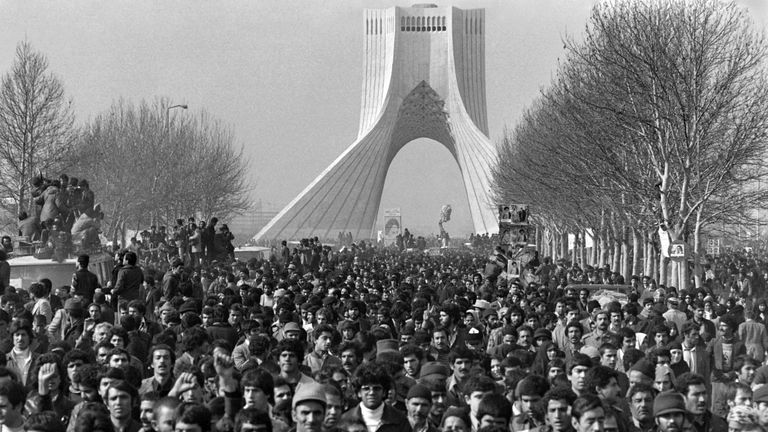 Hundreds of thousands of people greet Khomeini as he arrives in Tehran