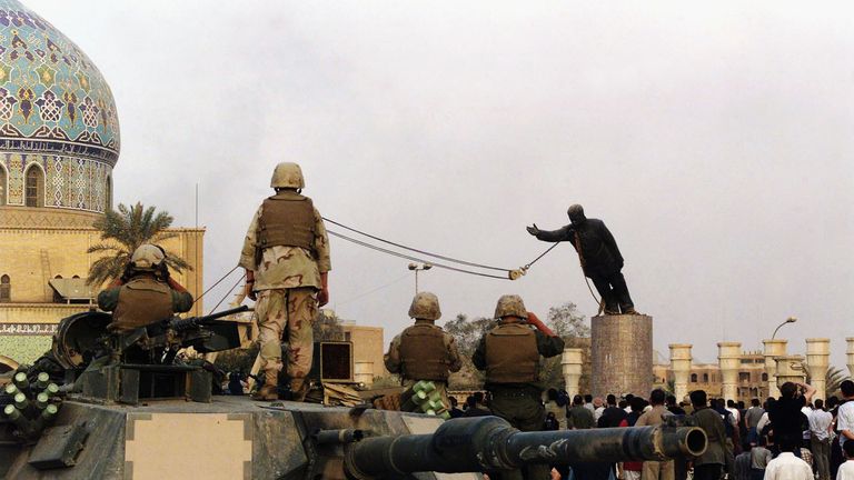 A statue of Saddam Hussein is pulled down by US soldiers after the invasion of Iraq in 2003