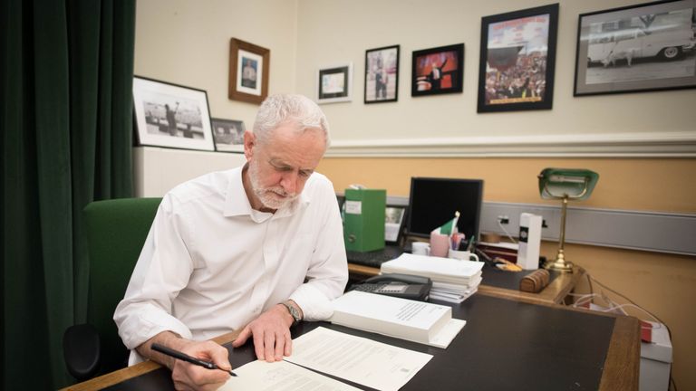 Labour leader Jeremy Corbyn signs a letter he has written to Prime Minister Theresa May laying out Labour&#39;s five Brexit demands before she goes to Brussels