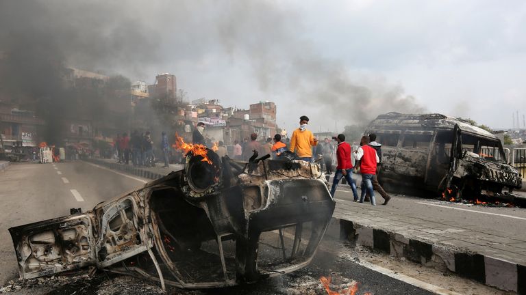 Vehicles were set alight by demonstrators after the bombing on Thursday