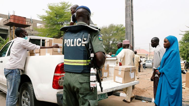 A police officer oversees the distribution of election materials in Yola