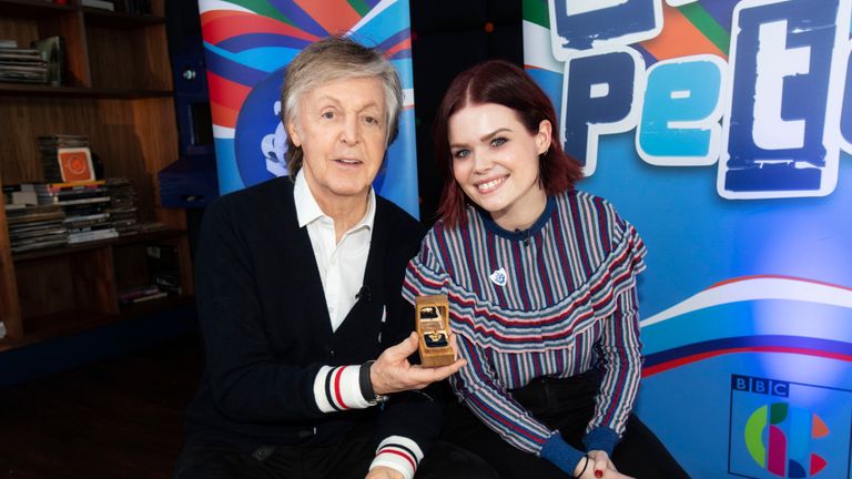Sir Paul McCartney with Blue Peter presenter Lindsey Russell receiving his gold Blue Peter badge