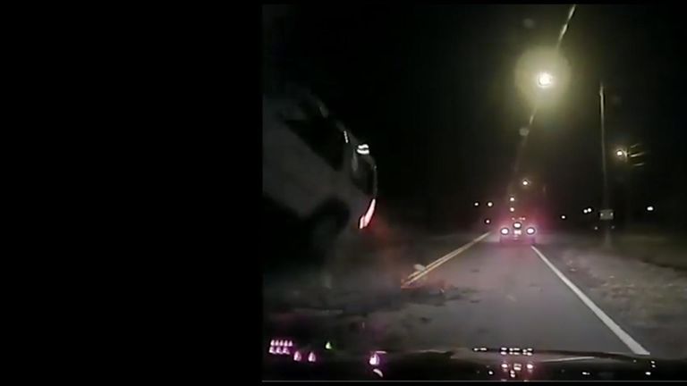 A rockslide caused a car to flip and hit an oncoming police cruiser.