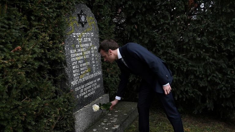 Emmanuel Macron paid his respects at a gravestone daubed with a swastika