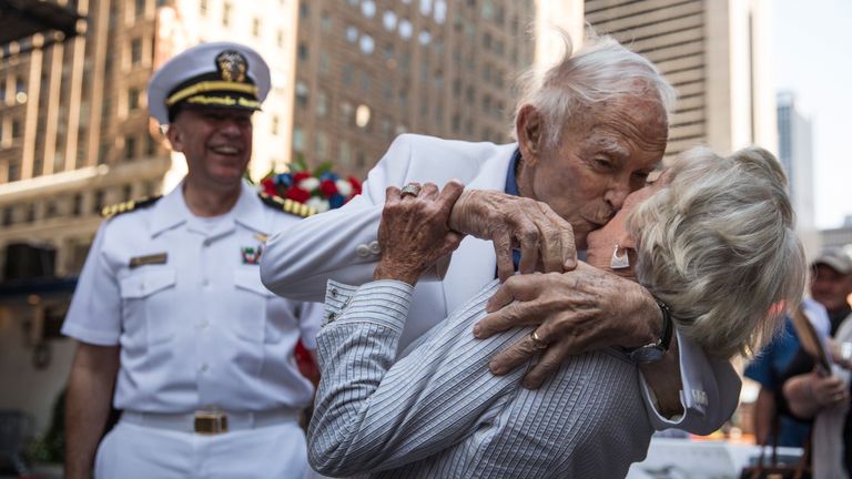 Sydnor Thompson, 90, kisses his wife, Harriette Thompson, 91, while re-enacting the kiss