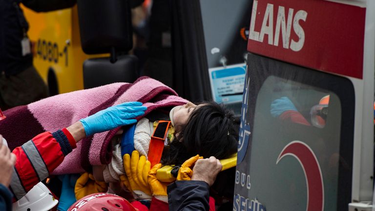 Turkish child Havva Tekgoz is evacuated by rescuers at the site 