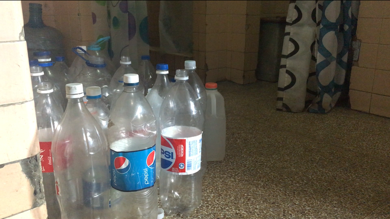 Patients bring empty bottles to fill with water to use the toilet