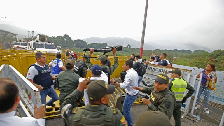 The moment two Venezuelan guards hand themselves to the Colombian authorities