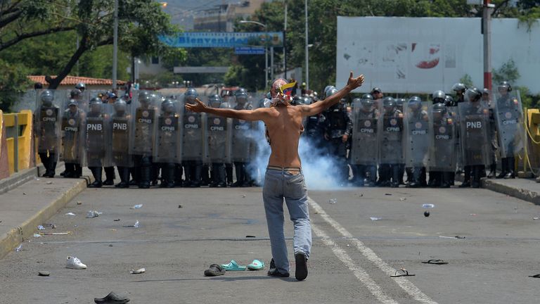 A man faces off against police at the Simon Bolivar bridge in Cucuta, Colombia 