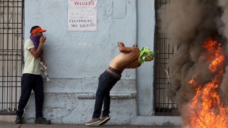 A protester is hit in the face by barbed wire during battles with guards in Urena