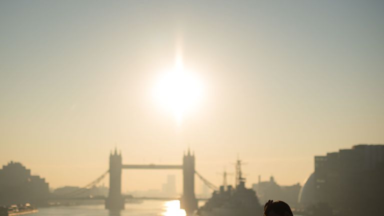 Commuters cross London Bridge as the last day of warm weather arrives