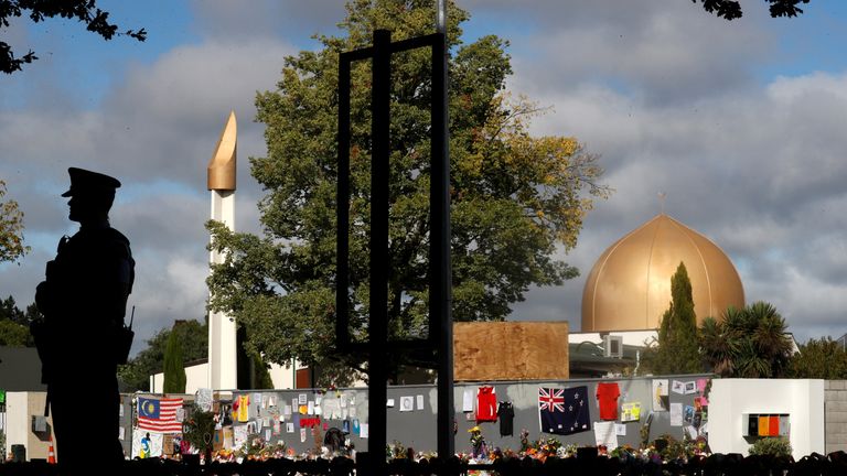 A police officer stands guard to provide reassurance near the al Noor mosque