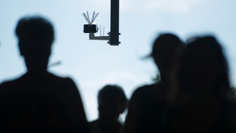 BERLIN, GERMANY - AUGUST 03: Passersby walk under a surveillance camera which is part of facial recognition technology test at Berlin Suedkreuz station on August 3, 2017 in Berlin, Germany. The technology is claimed it could track terror suspects and help prevent future attacks. (Photo by Steffi Loos/Getty Images)
