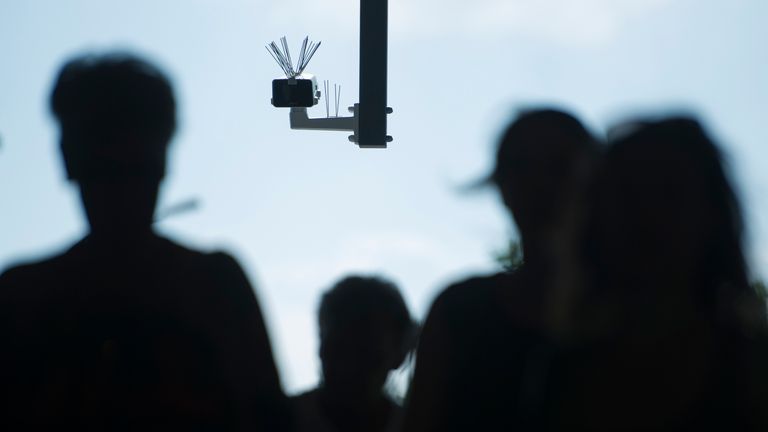 BERLIN, GERMANY - AUGUST 03: Passersby walk under a surveillance camera which is part of facial recognition technology test at Berlin Suedkreuz station on August 3, 2017 in Berlin, Germany. The technology is claimed it could track terror suspects and help prevent future attacks. (Photo by Steffi Loos/Getty Images)
