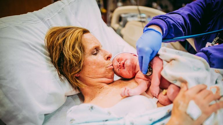 Cecile kisses her granddaughter for the first time