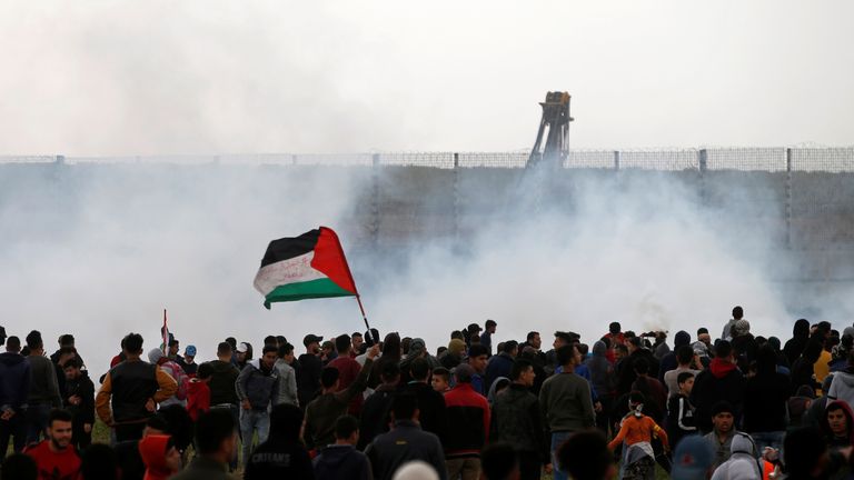 Palestinians gather as tear gas is fired by Israeli forces during a protest marking Land Day and the first anniversary of a surge of border protests, at the Israel-Gaza border fence east of Gaza City March 30, 2019. REUTERS/Mohammed Salem