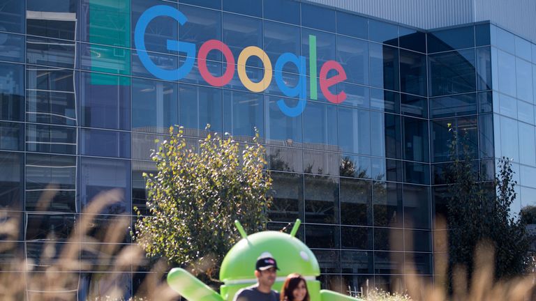 People pose for a picture near a Google sign and Android statue at the Googleplex in Menlo Park, California on November 4, 2016. / AFP PHOTO / JOSH EDELSON (Photo credit should read JOSH EDELSON/AFP/Getty Images)
