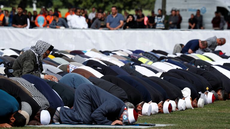 People perform Friday prayers a week after the shooting