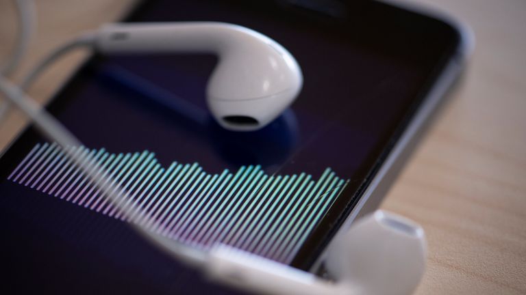 A picture taken on February 8, 2019 in Paris shows a smartphone and its earphones as an audio podcast is being played. (Photo by Thomas SAMSON / AFP) (Photo credit should read THOMAS SAMSON/AFP/Getty Images) 