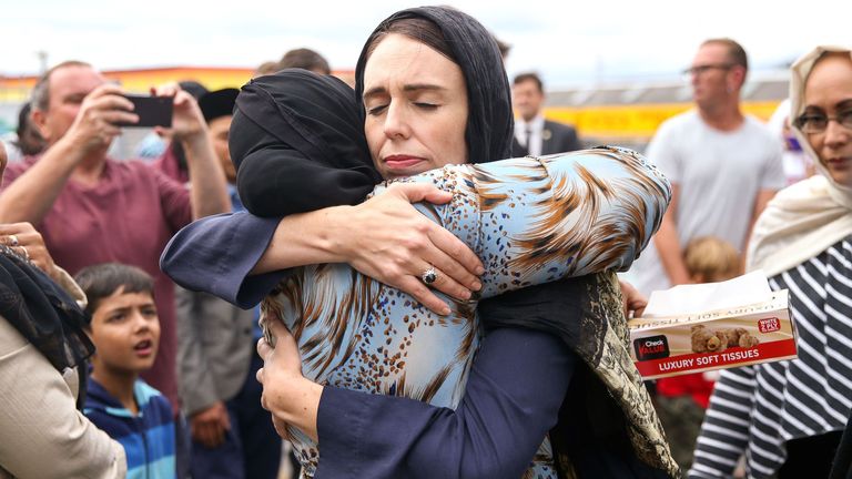 Jacinda Ardern embraces a woman outside a mosque