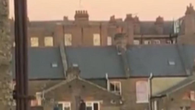 Two men on rooftop in police standoff