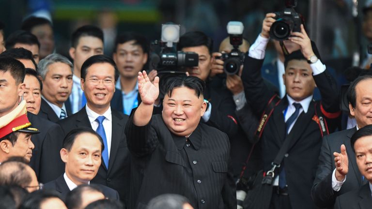 North Korea&#39;s leader Kim Jong Un (C) waves before boarding his train at the Dong Dang railway station in Lang Son on March 2, 2019