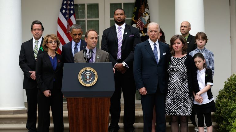 WASHINGTON, DC - APRIL 17: Mark Barden, the father of a victim at Sandy Hook Elementary School, joins U.S. President Barack Obama and Vice President Joe Biden in making a statement on gun violence in the Rose Garden of the White House on April 17, 2013 in Washington, DC