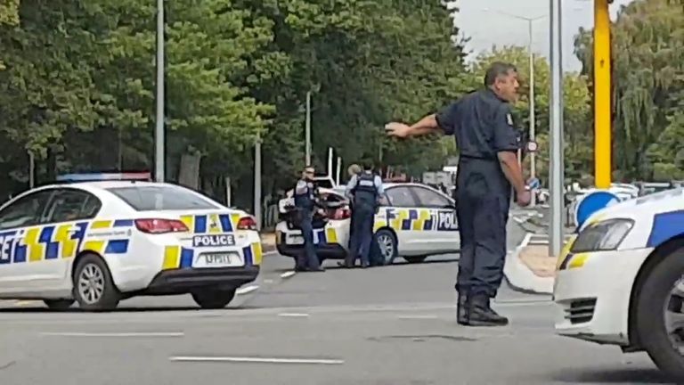 Police direct traffic at a road junction following the shootings