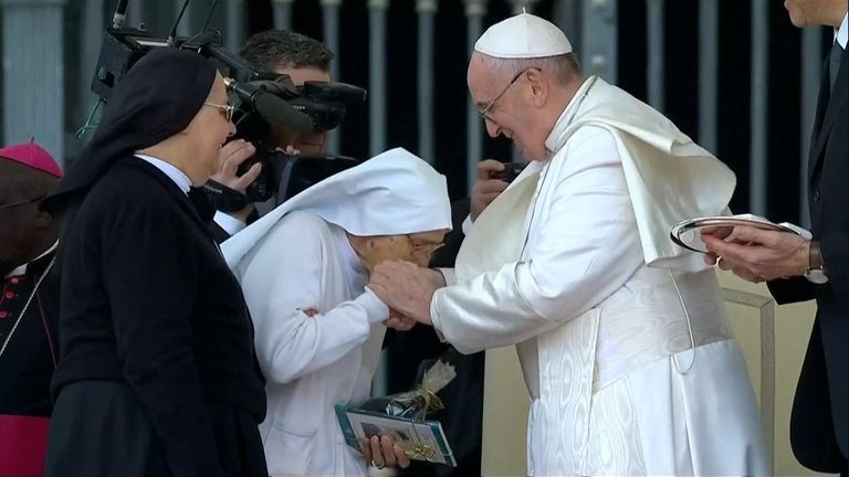 Pope accepting kisses from nuns at the Vatican