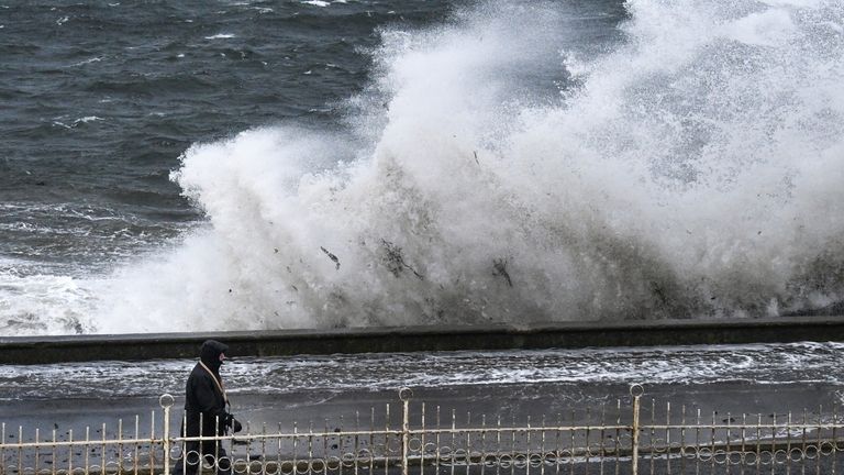 Members of the public look on as Storm Erik makes landfall with winds of up to 70mph due to hit some areas of the UK along with heavy rain on February 8, 2019 in Prestwick, Scotland