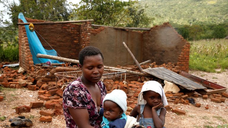 Nomatter Ncube and her kids sit beside their washed away family home following Cyclone Idai in Chimanimani district, Zimbabwe, March 18, 2019. REUTERS/Philimon Bulawayo
