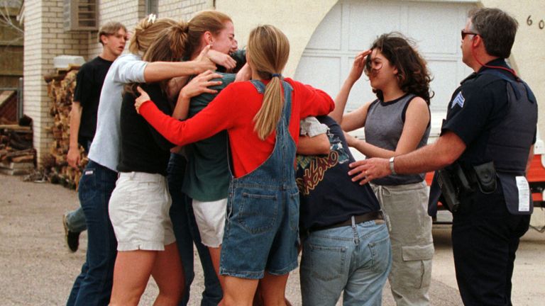  SHOOTINGRTRO9XJ21 Apr. 1999Littleton, USAColumbine high school students and friends rush and hug a friend who had just escaped from inside the high school where gunmen opened fire on terrified students, possibly killing up to 23 people before taking their own lives, police said. Jeff Stone, sheriff of Jefferson County, said the gunmen, students at the school, were found dead in the library on what he called a "suicide mission. 