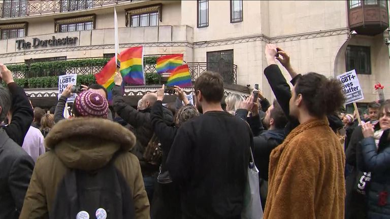 Demonstrators have been waving rainbow flags and holding up placards outside the hotel