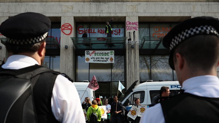 Activists sit with their tents in the road after sleeping at Oxford Circus on the second day of an environmental protest by the Extinction Rebellion group, in London on April 16, 2019.