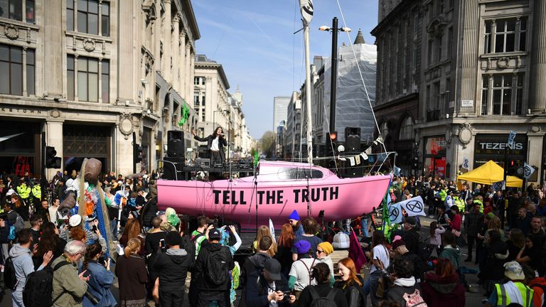 LONDON, ENGLAND - APRIL 15: Jessica Winter sings on a boat placed in the center of a traffic junction as Environmental campaigners block Oxford Circus during a coordinated protest by the Extinction Rebellion group on April 15, 2019 in London, England. With demonstrations blocking a number of locations across the capital, the group aims to stop traffic for up to five days. (Photo by Leon Neal/Getty Images)
