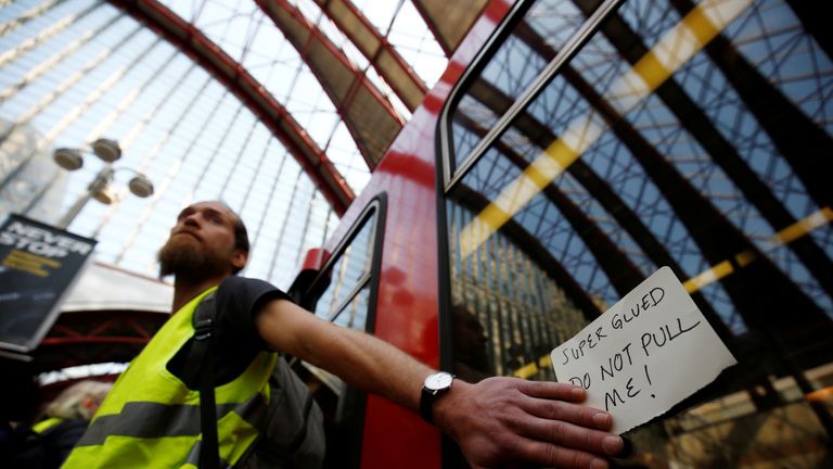 A climate change activist demonstrates during the Extinction Rebellion protest, at Canary Wharf DLR station in London, Britain April 17, 2019. REUTERS/Henry Nicholls