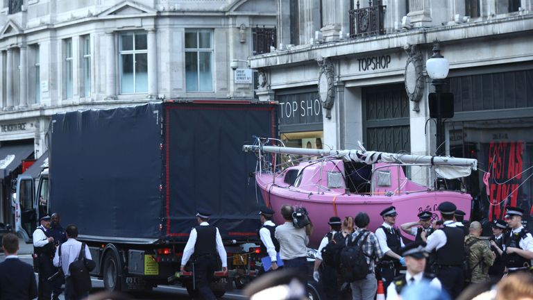 The Extinction Rebellion boat is towed away