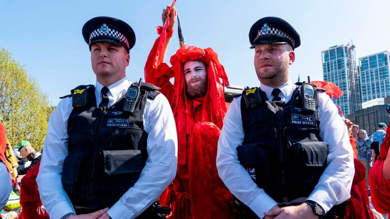 Police and a climate activist on Waterloo Bridge in central London